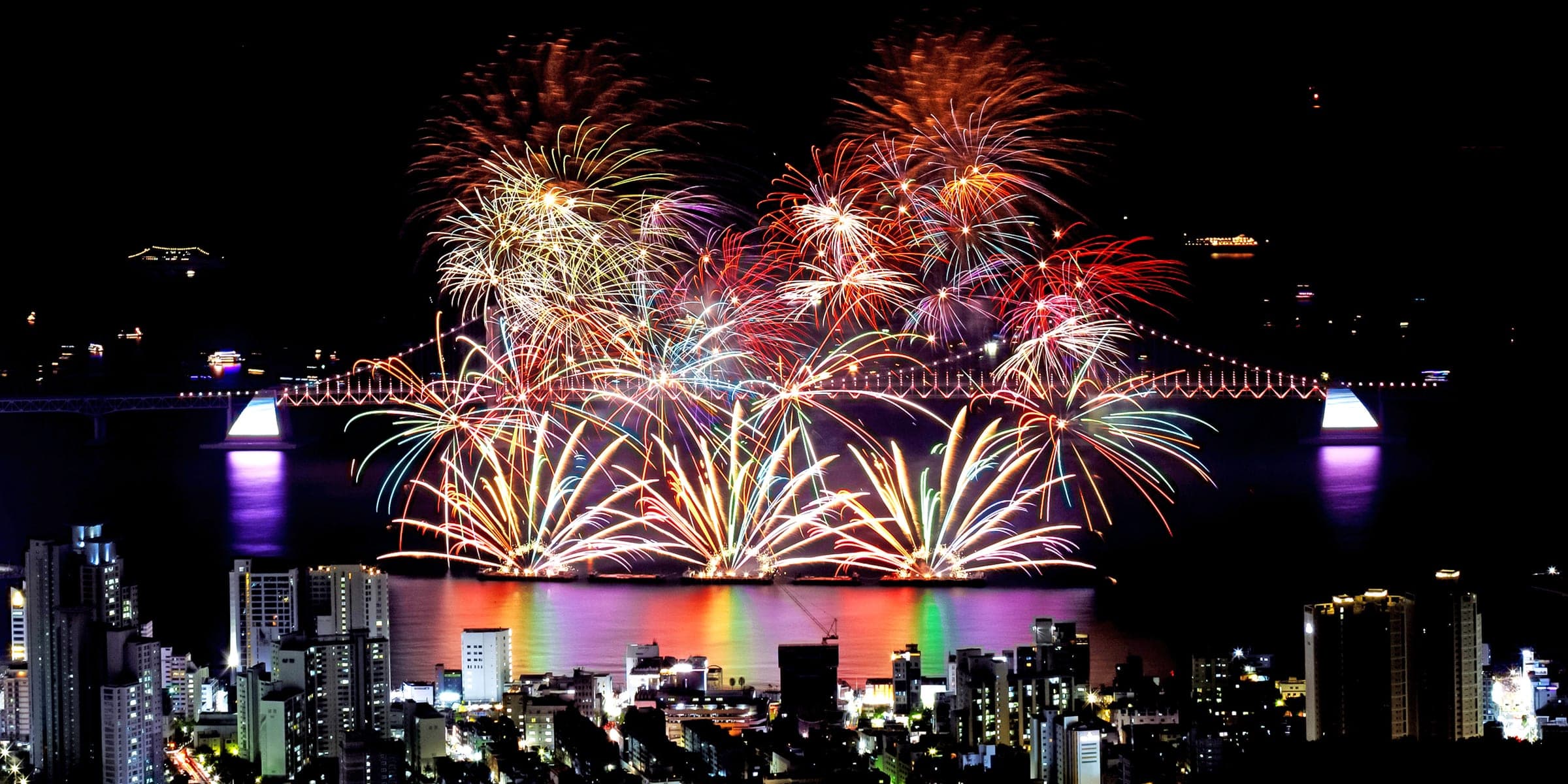 Fireworks over Gwangan Bridge during the Busan Fireworks Festival, seen from the hills above Gwangalli