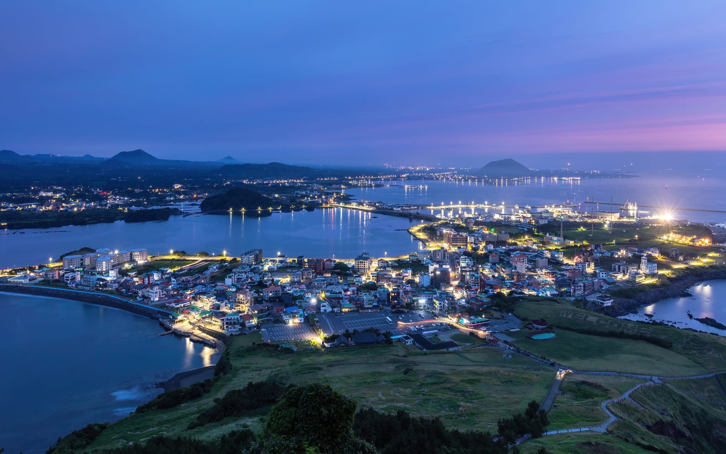 Seongsan-ri town and the coastline seen from Seongsan Ilchulbong at dusk