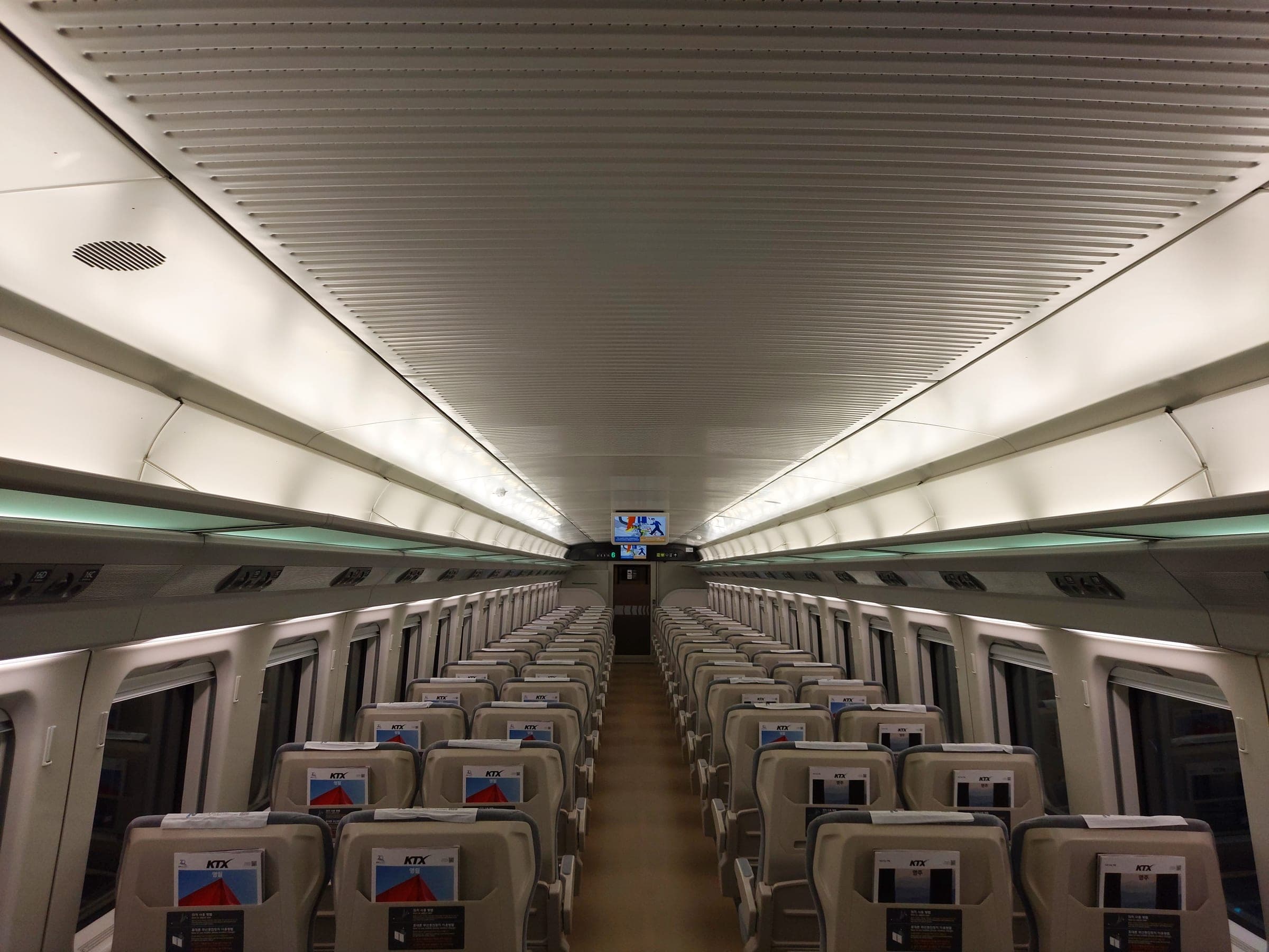 Rows of forward-facing standard class seats inside a KTX-Cheongryong carriage