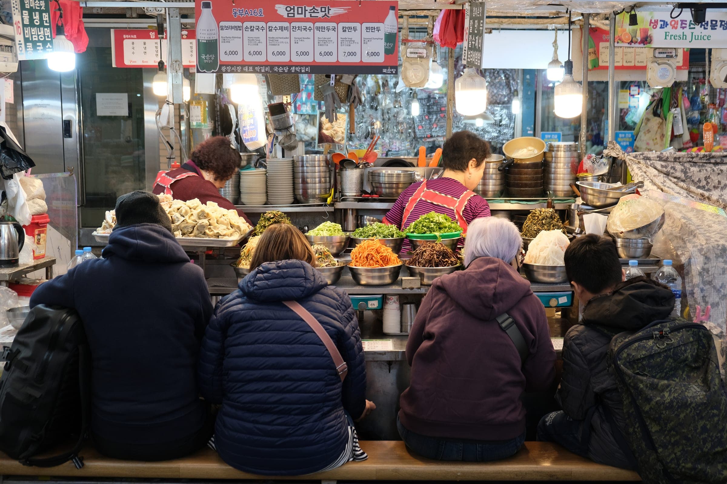 Lit shopfronts of the Dongdaemun shopping complex after dark